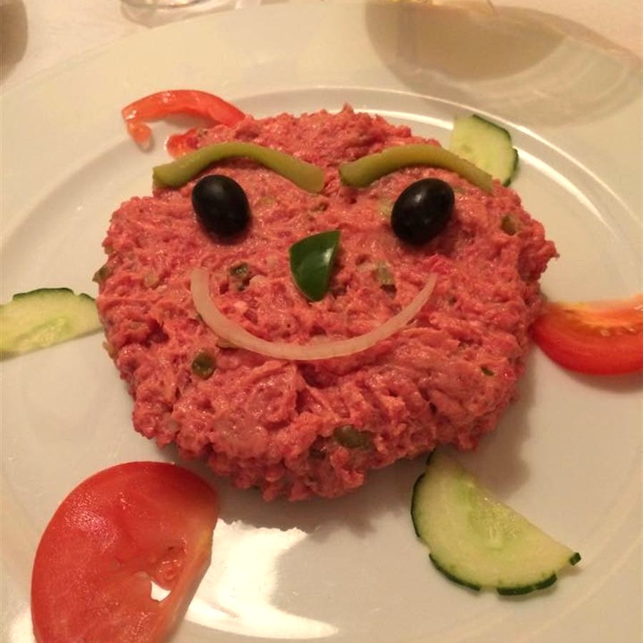 A playful starter plate decorated with a smiling face at Um Grill