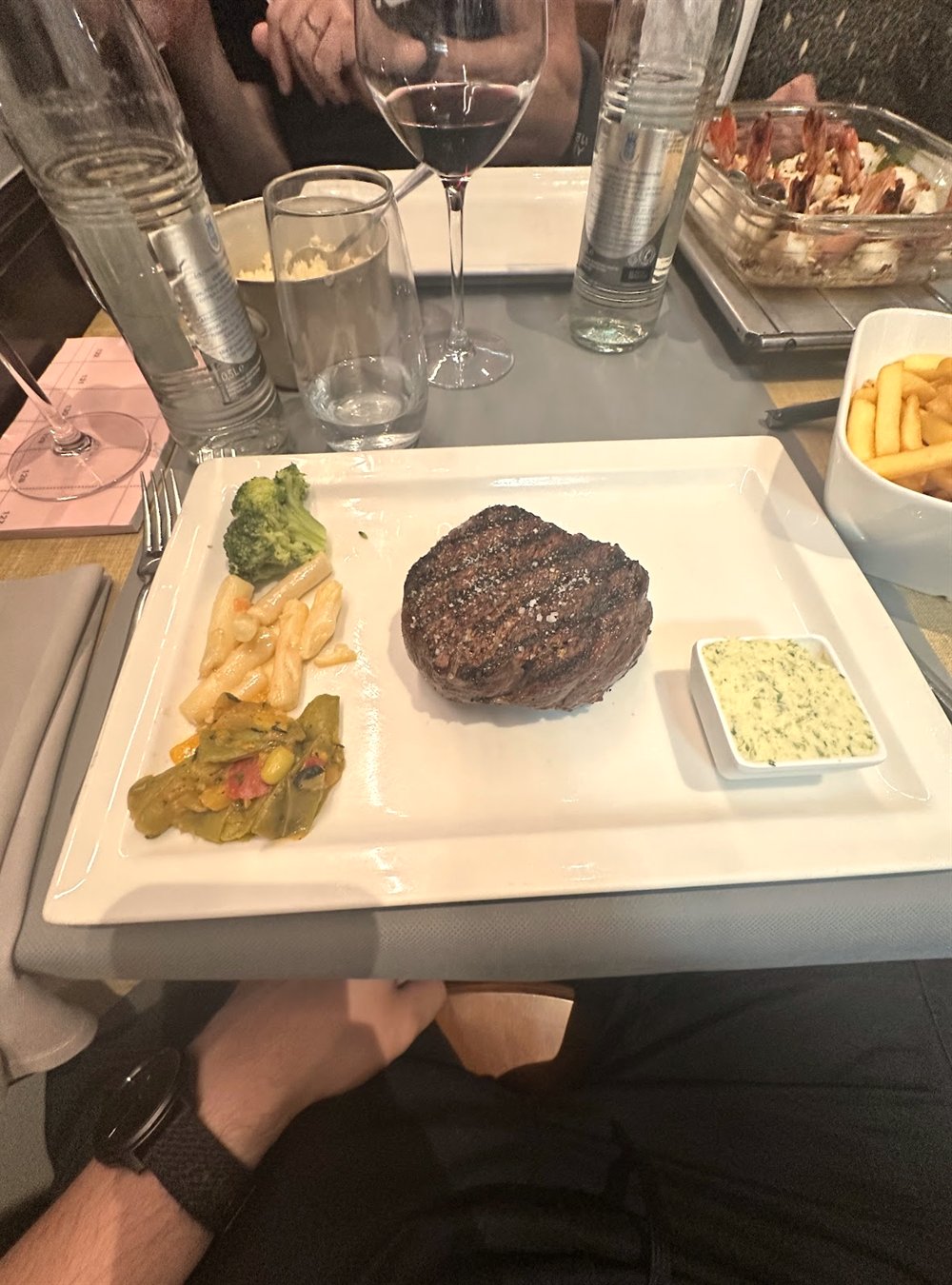Grilled steak with fries and pasta at Um Grill